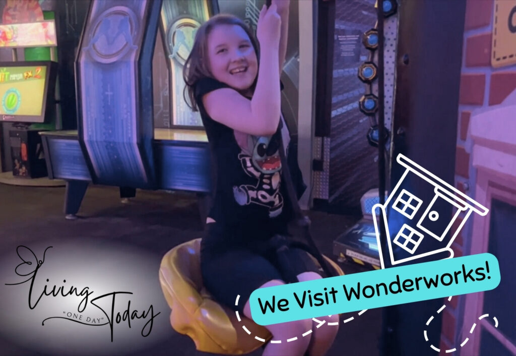 Photo of young girl doing an activity at WonderWorks in Orlando, Florida. Logo text in bottom left says Living One Day Today. Bottom right text says We Visit WonderWorks.